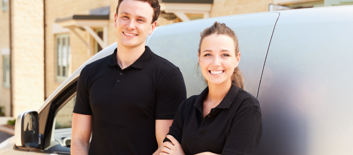 Man and Woman business owner standing in front of a van